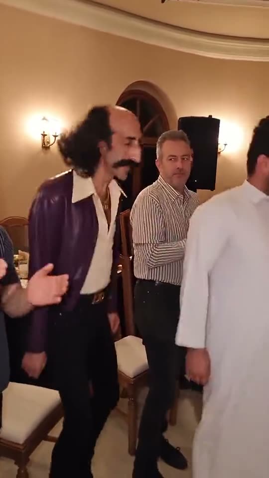 Frame from a Party Viral Dance AI video: the dancer glides along the row of guests