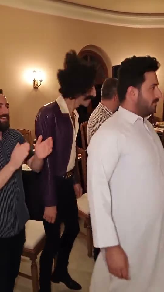 Party Viral Dance trend: a tall man in a long white robe next to the dancer